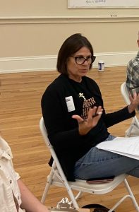 Woman sitting on chair gesturing with hands